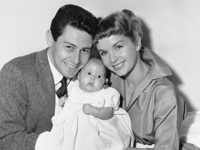 Eddie Fisher and Debbie Reynolds hold their baby daughter, Carrie Frances Fisher, in this 1957 photo. Picture: AP