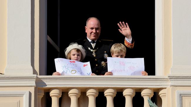 Prince Albert, Princess Gabriella and Prince Jacques stand with a message for Princess Charlene on November 19, 2021. Picture: Valery Hache/AFP