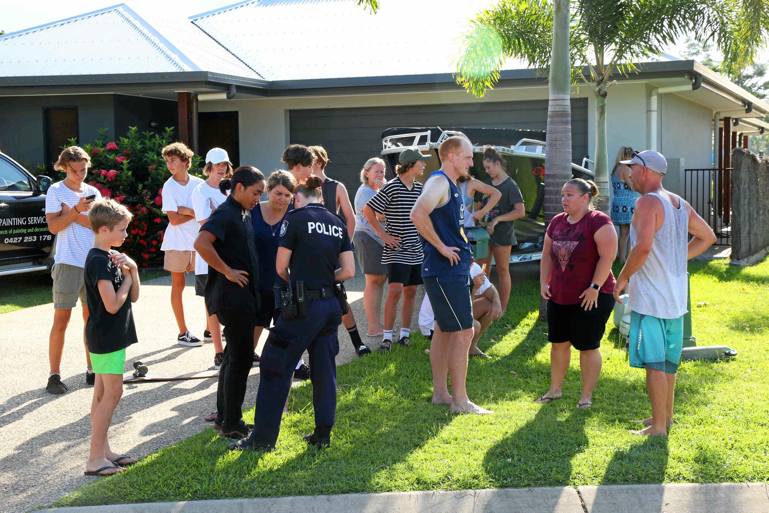 Residents of Waite Creek Ct in Cannonvale look on as a house is engulfed by flames. Picture: PETER CARRUTHERS