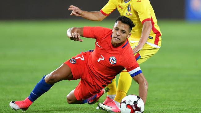 Alexis Sanchez (L) of Chile vies for the ball with Alin Tosca (R) of Romania