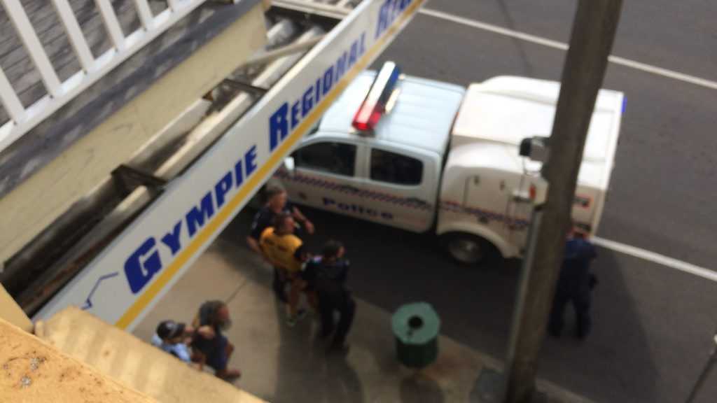 A protester is lead away by police outside the Gympie Regional Council office in Mary St. Picture: Contributed