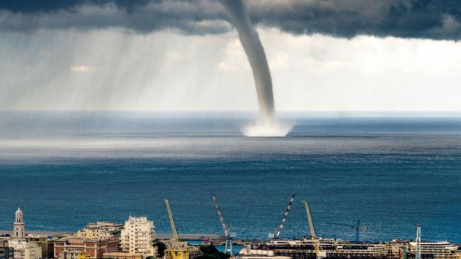 *ONE TIME WEB USE ONLY* *Contact Network for print use* PIC BY EVGENY DROKOV / CATERS NEWS - (PICTURED: The waterspout decends on the bay off the coast of Genoa, Italy.) - These amazing pictures show a TORNADO hitting the coast of an Italian town.The incredible snaps show the stormy skies over Genoa, Italy, as the tornado sweeps over the sea.The dark, blustery clouds filled the sky as the twister pummelled the ocean, with dramatic flashes of lightening and rumbles of thunder. The dramatic pictures were caught on camera by Evgeny Drokov, from Russia, who was on holiday with his family.SEE CATERS COPY.