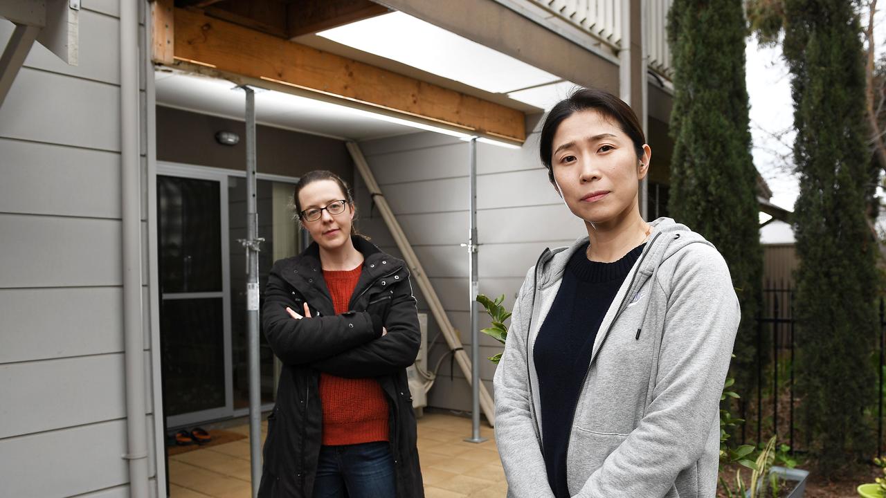 Katherine Padget and So Young Myung outside their Angle Park apartments. The balconies of the eight-unit complex are being propped up amid an ongoing dispute with insurers and the builder. Picture: Mark Brake