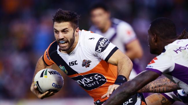 SYDNEY, AUSTRALIA - APRIL 17: James Tedesco of the Tigers takes on the defence during the round seven NRL match between the Wests Tigers and the Melbourne Storm at Leichhardt Oval on April 17, 2016 in Sydney, Australia. (Photo by Matt King/Getty Images)