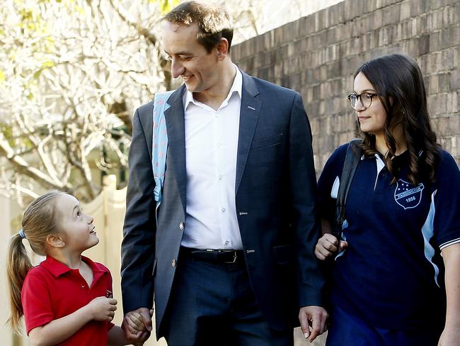 Dave Sharma walks daughters Daphne, then 7, and Estella, 11, to school. Picture: John Appleyard