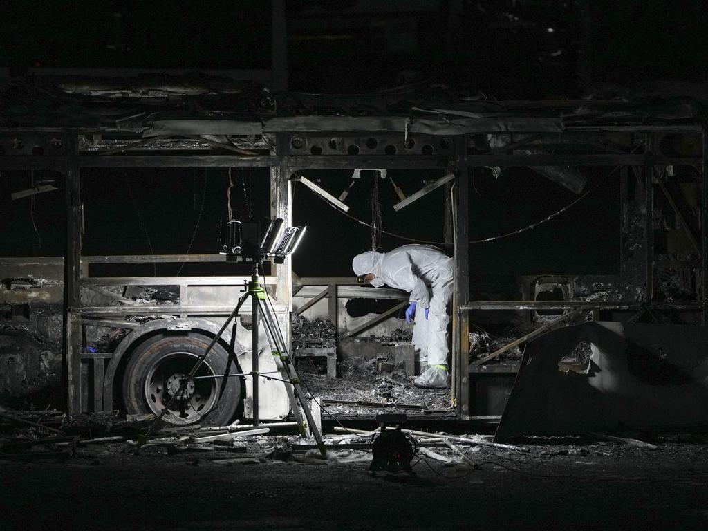 An Israeli police officer inspects the scene of one of a series of bus explosionsin in Bat Yam, central Israel. Picture: AP