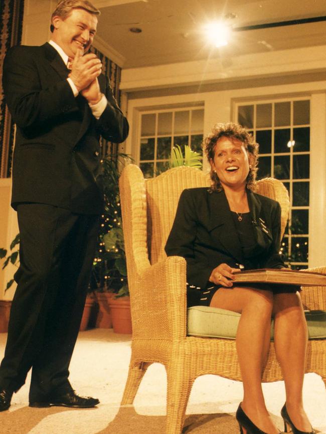 Host Mike Munro of 'This Is Your Life' gives Evonne Goolagong Cawley a book on her life in 1996.