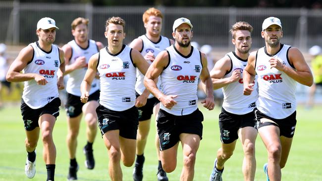 Port Power players during a training session at Alberton Oval. The team is embracing Adelaide’s hot spell. Picture: AAP Image/Mark Brake