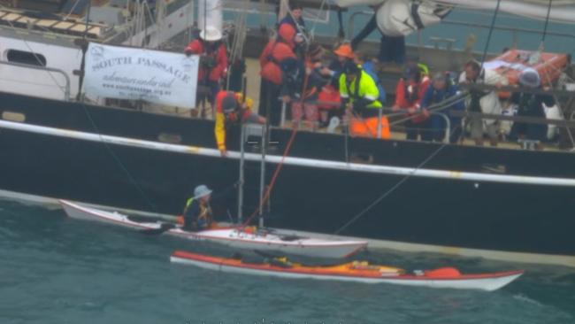 A screen grab from a video showing the dramatic rescue by crew aboard the tall training ship, South Passage, of two kayakers off Hinchinbrook Island in North Queensland on Thursday. Picture: Supplied