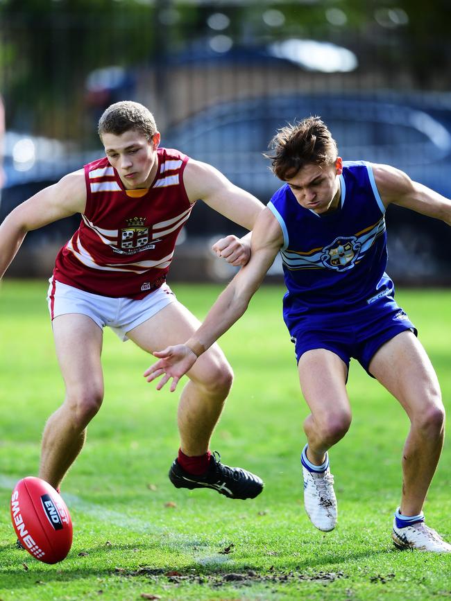 PAC’s Josh Perkins competes with Sacred Heart’s Xavier Robbins. Picture: AAP/Mark Brake