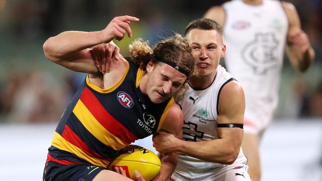 Young Blue Corey Durdin tackles Crow Sam Berry. Picture: Sarah Reed/AFL Photos