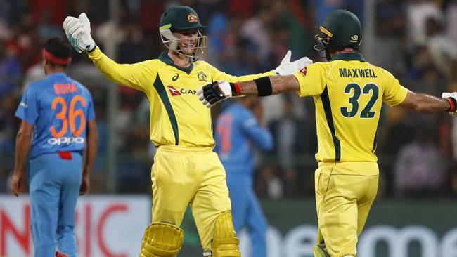 Peter Handscomb and Glenn Maxwell embrace at the end of the innings. (AP Photo/Aijaz Rahi)