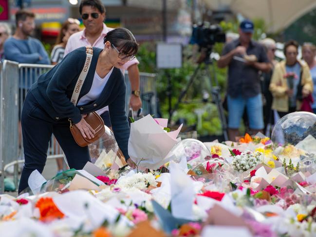 People return to Bondi Junction Westfields to bring flowers and show their respect. Picture Thomas Lisson