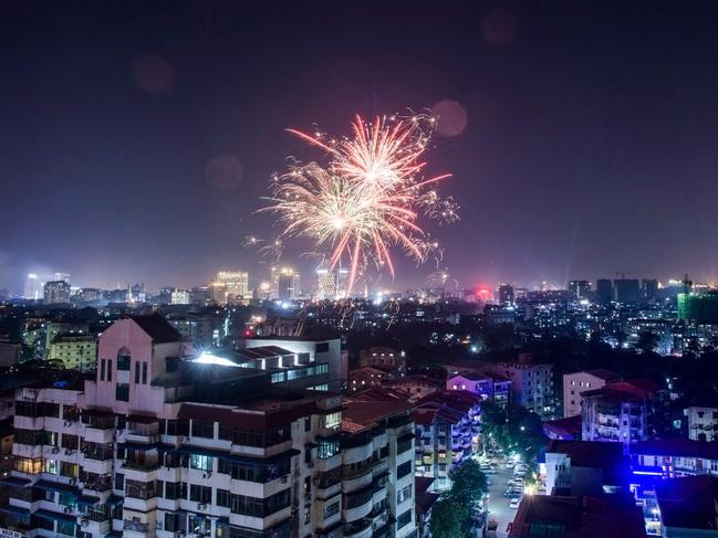 Fireworks explode over the city during New Year celebrations in Yangon on January 1, 2019. Picture: AFP