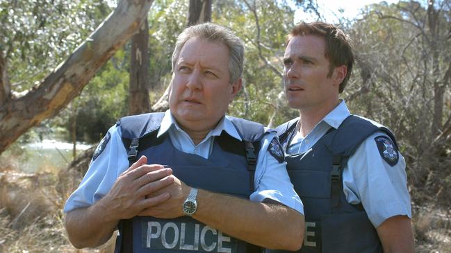 Actor John Wood with Ditch Davey in scene from Blue Heelers.