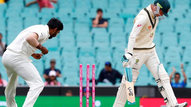 Peter Handscomb walks off after being bowled by Jasprit Bumrah.