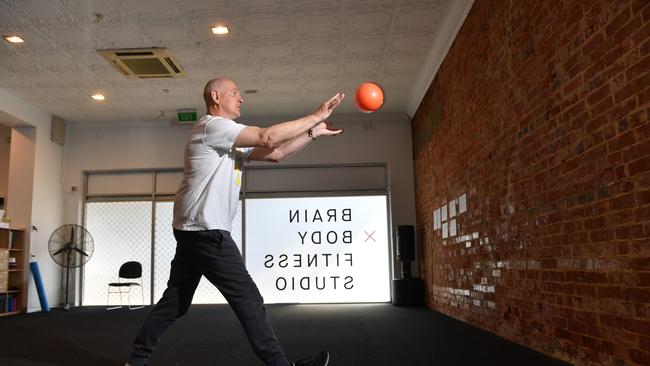 Former AFL player Mark Mickan, 59, Fulham who was diagnosed with Parkinson's disease in August 2016 doing rehab work in the gym, Brain Body Fitness Studio. Picture: Keryn Stevens