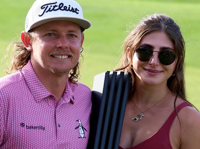 ST ALBANS, ENGLAND - JULY 09: Cameron Smith of Australia poses with his girlfriend Shanel Naoum after his win on day three of LIV Golf - London at The Centurion Club on July 09, 2023 in St Albans, England. (Photo by Tom Dulat/Getty Images)