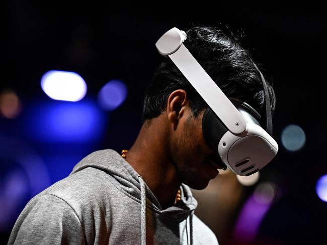 A man tries the Meta Quest 3 mixed reality VR headset during the Vivatech technology startups and innovation fair, at the Porte de Versailles exhibition center in Paris, on May 22, 2024. (Photo by JULIEN DE ROSA / AFP)