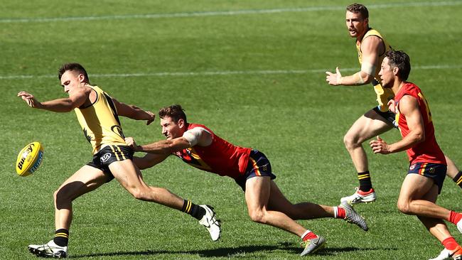 North Adelaide’s Aidan Tropiano latches on to WA’s Josh Deluca during the state clash at Optus Stadium. Picture: Paul Kane/Getty Images