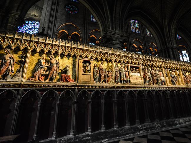 The dark, gothic interior of the Notre Dame Cathedral in Paris France showing a portion of the Rose Window. Picture: Alamy