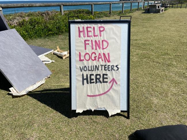 A sign asking for volunteers to help join the search for missing 20-year-old Logan Losurdo at North Entrance Surf Club.