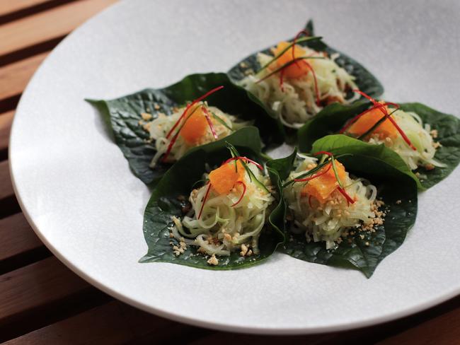 Betel leaves topped with crushed peanut, toasted coconut, green papaya, crispy soy, citrus fruit and nahm jim dressing from Bodhi restaurant, in the CBD.