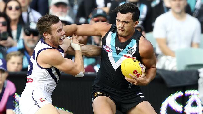 Port Adelaide rookie sensation Sam Powell-Pepper with a trademark fend-off against Docker Ed Langdon. Picture: Sarah Reed.