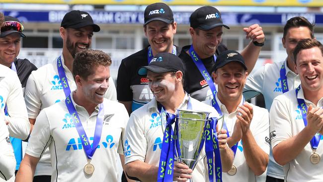 New Zealand's stand-in captain Tom Latham holds the trophy as the team celebrates winning the Test series over England Picture: AFP