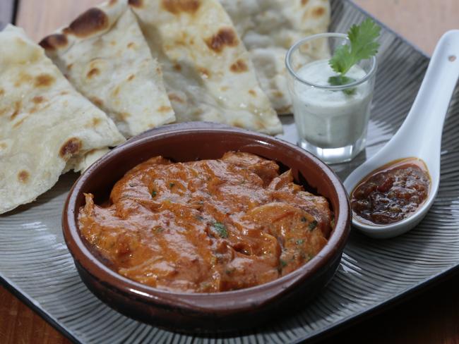 Prawn curry with naan bread served with side dishes of cucumber yoghurt and homemade pickle from The Flat Rock Brew Cafe.