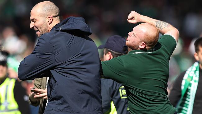 Hibs and Rangers fans fight after they invade the pitch.