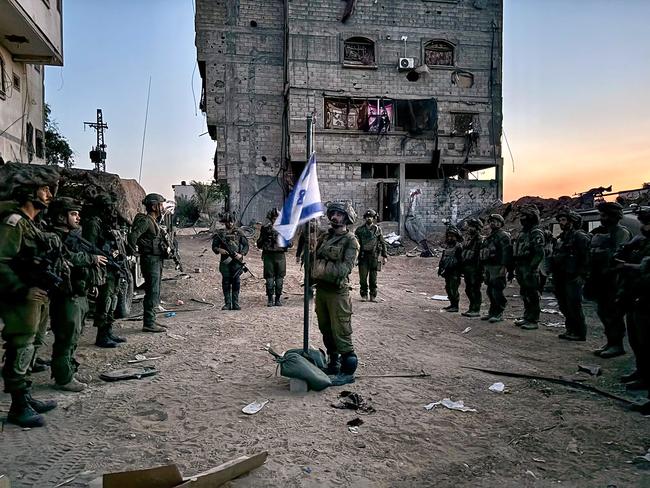 TOPSHOT - This handout picture released by the Israeli army on May 13, 2024 shows Israeli soldiers who are operating in the Gaza Strip, attending a ceremony as part of the national Memorial Day for fallen soldiers of Israel's wars and victims of attacks, amid the ongoing conflict between Israel and the Palestinian militant group Hamas. (Photo by Israeli Army / AFP) / === RESTRICTED TO EDITORIAL USE - MANDATORY CREDIT "AFP PHOTO / Handout / Israeli Army' - NO MARKETING NO ADVERTISING CAMPAIGNS - DISTRIBUTED AS A SERVICE TO CLIENTS ==