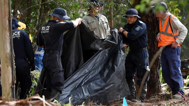 NSW Police cover an area they were looking at with plastic tarpaulin in an area of bush, 1km from the former home of William Tyrrell. Picture: AAP Image