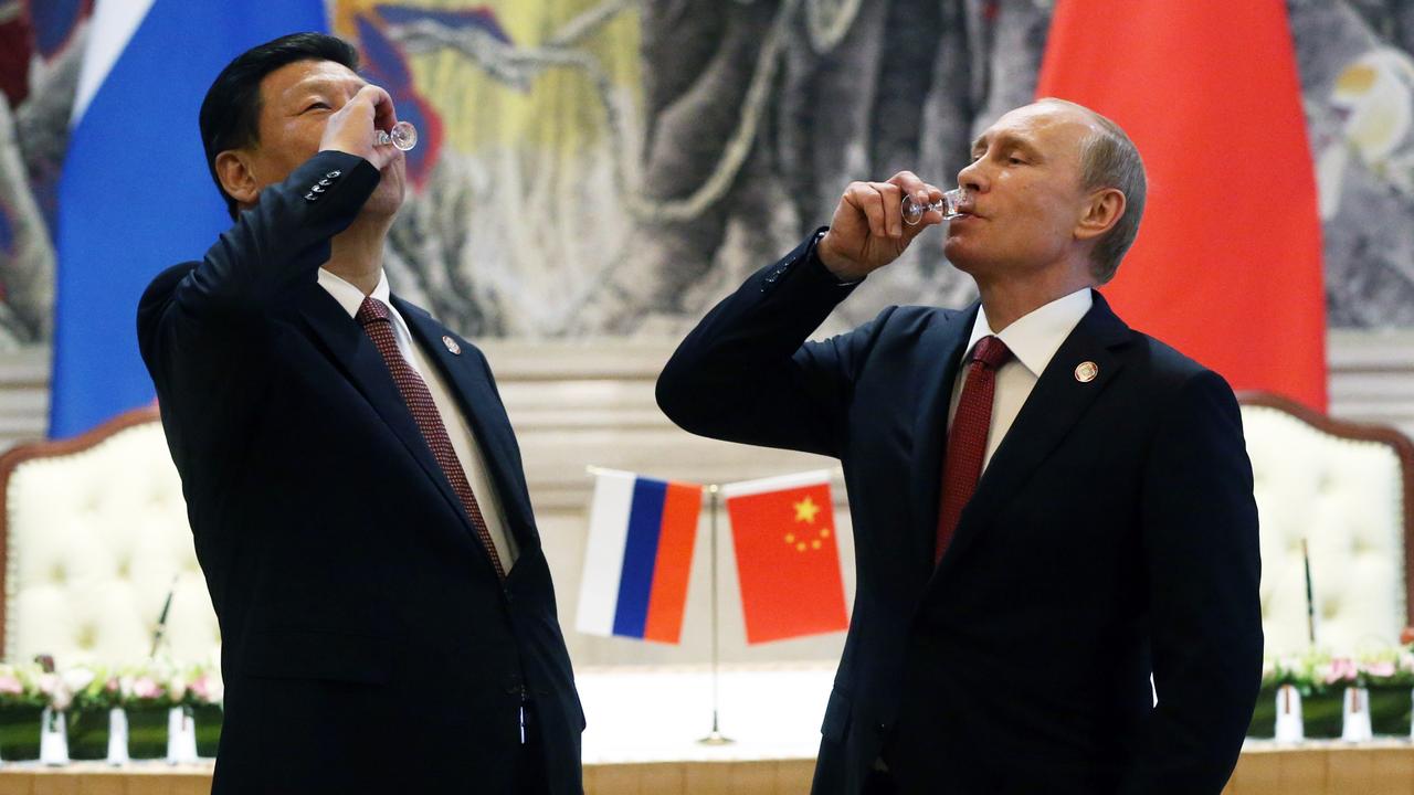 Chinese President Xi Jinping and Russian President Vladimir Putin toast with vodka during a signing ceremony in 2014. Picture: Sasha Mordovets/Getty Images