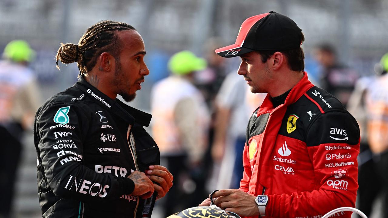 (FILES) Mercedes' British driver Lewis Hamilton (L) speaks with Ferrari's Monegasque driver Charles Leclerc after the Sprint race at the Circuit of the Americas in Austin, Texas, on October 21, 2023 ahead of the United States Formula One Grand Prix. Mercedes star Lewis Hamilton and Ferrari's Charles Leclerc were both disqualified from Sunday's October 22 US Grand Prix after their cars failed post-race inspections. Former world champion Hamilton had finished second behind Max Verstappen in Austin while Leclerc came in sixth. Both drivers saw those results scratched, however, after a technical team found excessive wear of their cars floor planks. (Photo by Chandan Khanna / AFP)