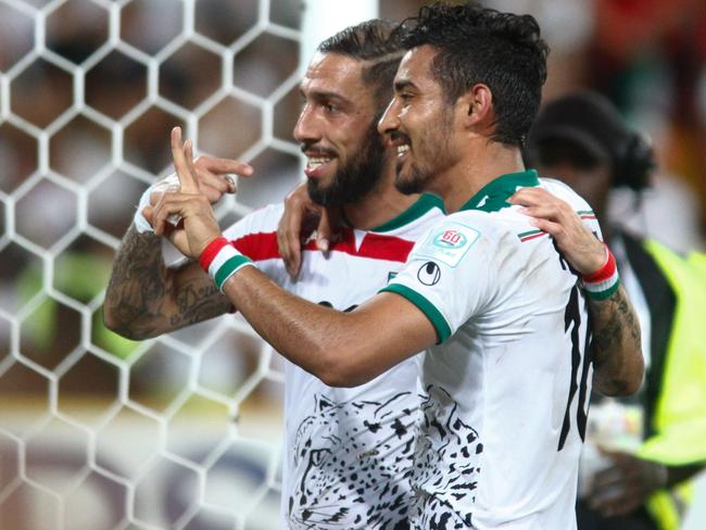 Ashkan Dejagah (R) and Reza Ghoochannejhad of Iran celebrate at the end of the match against the United Arab Emirates after their Group C football match at the AFC Asian Cup in Brisbane on January 19, 2015. AFP PHOTO / John PRYKE --- IMAGE RESTRICTED TO EDITORIAL USE - STRICTLY NO COMMERICAL USE --