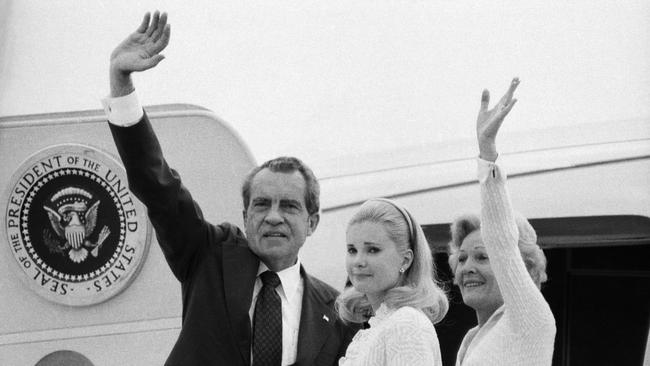 Richard Nixon, his wife Pat and daughter Tricia boarding a plane following his resignation.