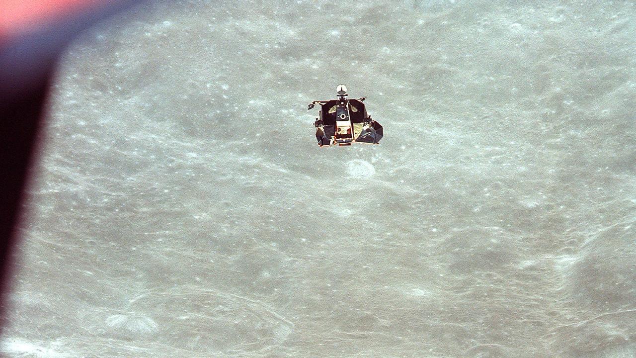 21/07/1969. The Apollo 11 Lunar Module (LM) ascent stage, with astronauts Neil A. Armstrong and Edwin E. Aldrin, Jr. aboard, is photographed from the Command and Service Modules (CSM) in lunar orbit. Astronaut Michael Collins, command module pilot, remained with the CSM in lunar orbit while Armstrong and Aldrin explored the Moon. The LM is approaching from below. The co-ordinates of the centre of the lunar terrain seen below is located at 102 degrees east longitude and 1 degree north latitude. MUST CREDIT NASA - NO FEE APPLIES.
