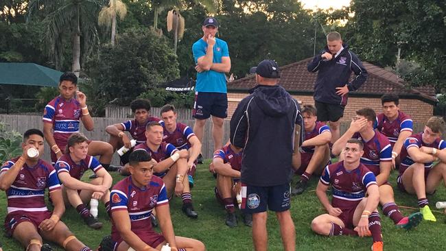 Wavell SHS listen to a halftime address by coach Jim Francis during the Langer Cup.