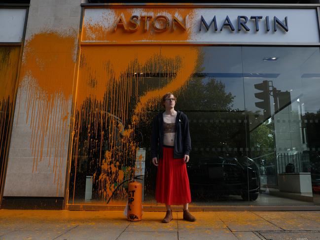 A demonstrator from the same group sprayed an orange substance on an Aston Martin store in Mayfair in London, England on Sunday. Picture: Hollie Adams/Getty Images