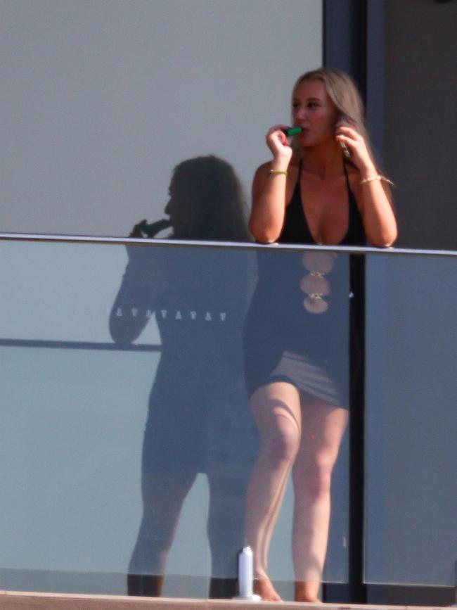 This woman was spotted on the balcony. Picture: KHAPBM / BACKGRID