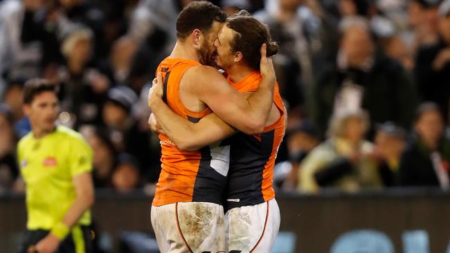 Mumford and Phil Davis react after the final siren sounded. Picture: Michael Willson/AFL Photos via Getty Images