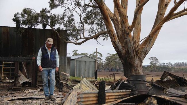 What cost?: Cattle farmer Brad Gilmour surveys the damage to his property near Terang after the 2018 St Patrick’s Day fire. Source: ABC News