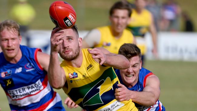 2021 Magarey Medallist James Tsitas tussles against Central District. All players in SANFL competitions will need to be fully vaccinated ahead of next season. Picture: Naomi Jellicoe