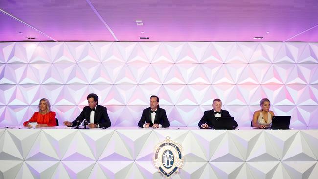 Gillon McLachlan reads the votes in the Metricon ‘Brownlow Bunker’ with other officials. Picture: AFL Photos/Getty Images