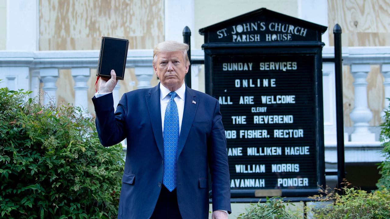 US President Donald Trump holds a Bible while visiting St John's Church across from the White House after the area was cleared of protesters. Picture: Brendan Smialowski/AFP