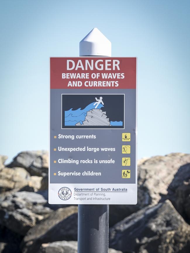 Warning signs near where police divers recovered the body of the missing girl. Picture: Mike Burton