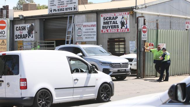 Police interview employees at the scrap metal yard. Picture: Emma Brasier