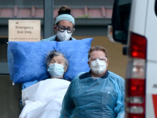 Medical staff remove patients from St Basil’s at Fawkner. Picture: Andrew Henshaw