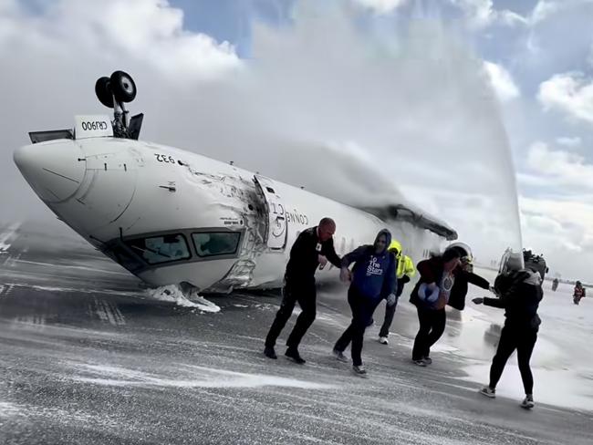 Images shot  by passenger Pete Koukov who was on a Delta Air Lines plane that crashed while landing Monday afternoon at the snowy Toronto Pearson International Airport. Picture: Pete Koukov/@eggxit Instagram